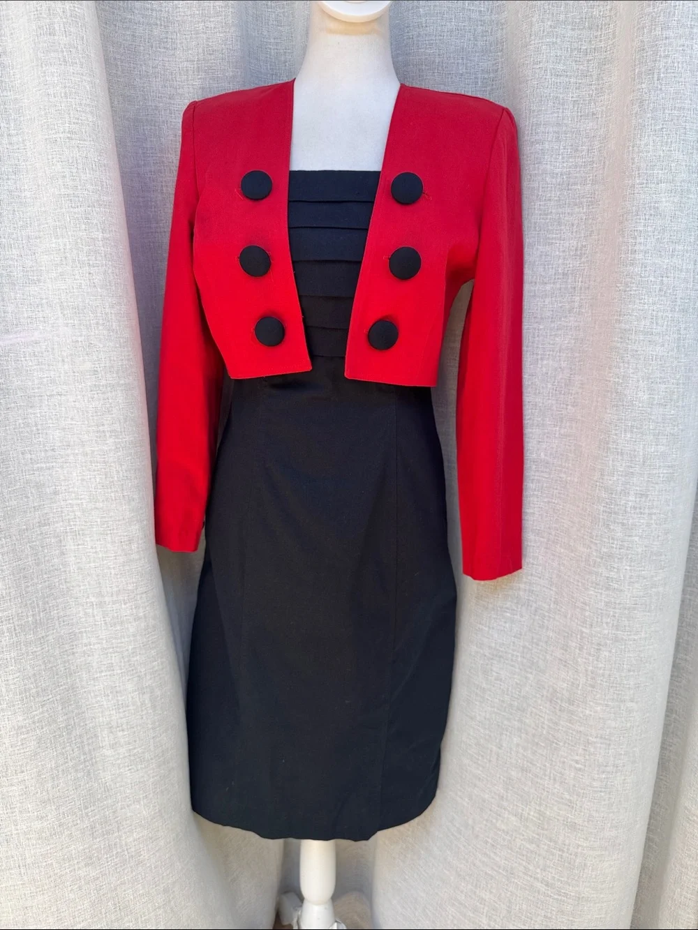 Jillian Arthur 1990s black strapless dress paired with a red bolero crop blazer